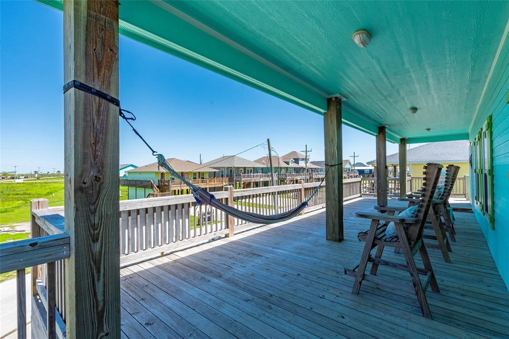 987 Surf Crystal Beach Crystal Beach, TX 77650 - Photo 28 of 45 a view of a chairs and table in patio with wooden fence
