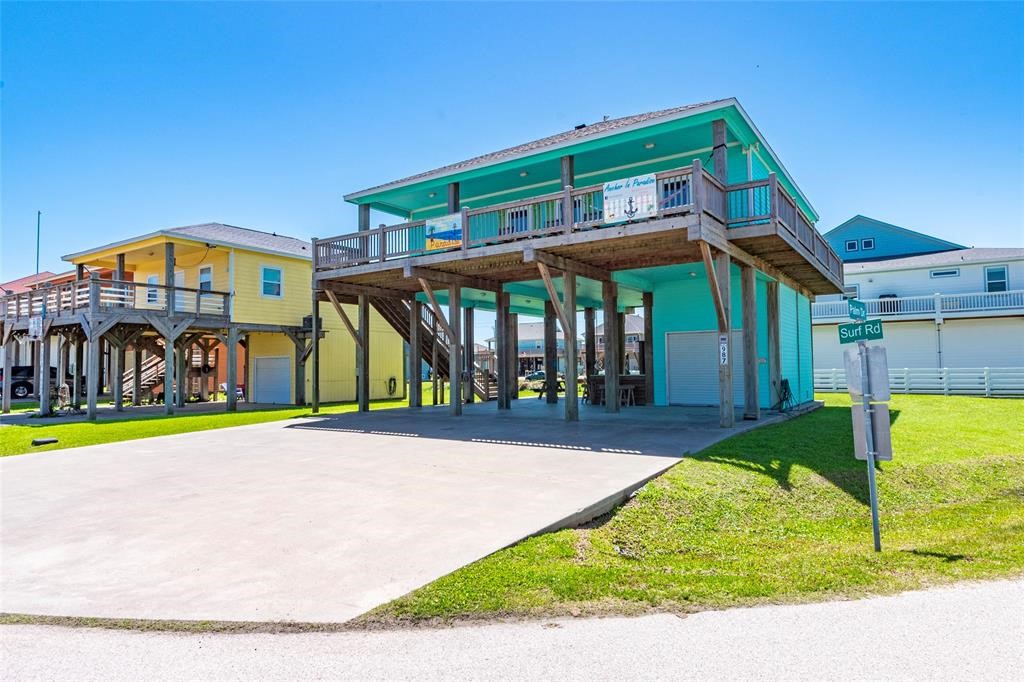 987 Surf Crystal Beach Crystal Beach, TX 77650 - Photo 30 of 45 a front view of a house with a yard