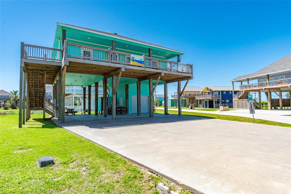 987 Surf Crystal Beach Crystal Beach, TX 77650 - Photo 31 of 45 a view of a building with a swimming pool