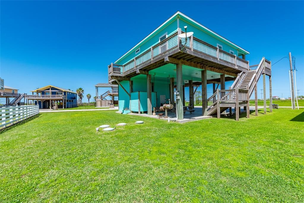 987 Surf Crystal Beach Crystal Beach, TX 77650 - Photo 39 of 45 a backyard of a house with table and chairs