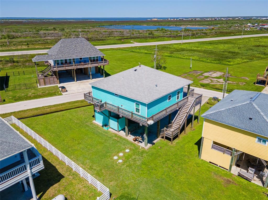 987 Surf Crystal Beach Crystal Beach, TX 77650 - Photo 42 of 45 a aerial view of a house with a garden and pool