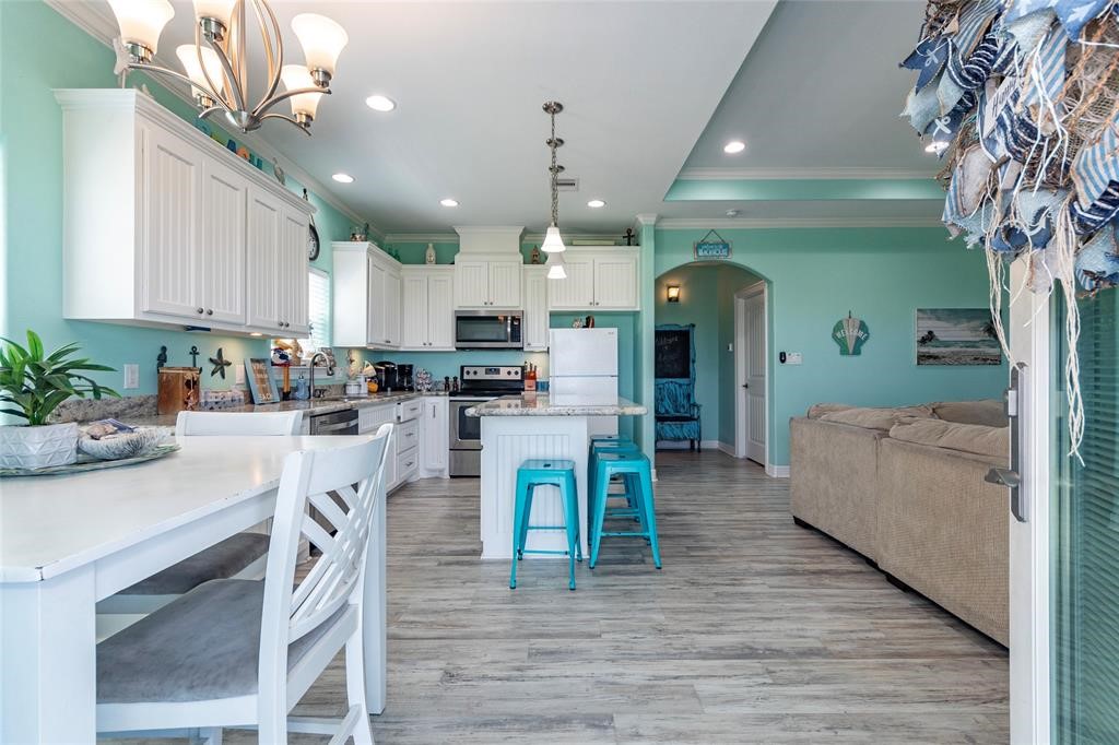 987 Surf Crystal Beach Crystal Beach, TX 77650 - Photo 5 of 45 a view of a kitchen with dining table and chairs
