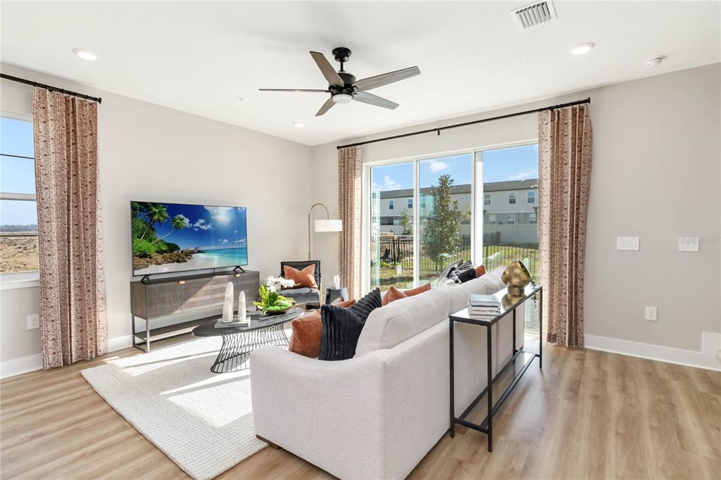 1109 Orange Trailside Way Ocoee, FL 34761 - Photo 6 of 32 a living room with furniture and a large window