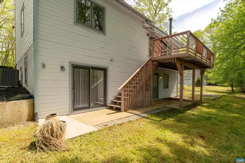 a view of a house with a small yard and wooden fence