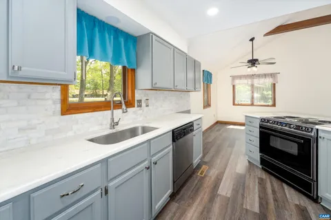 a kitchen with a sink stove and cabinets