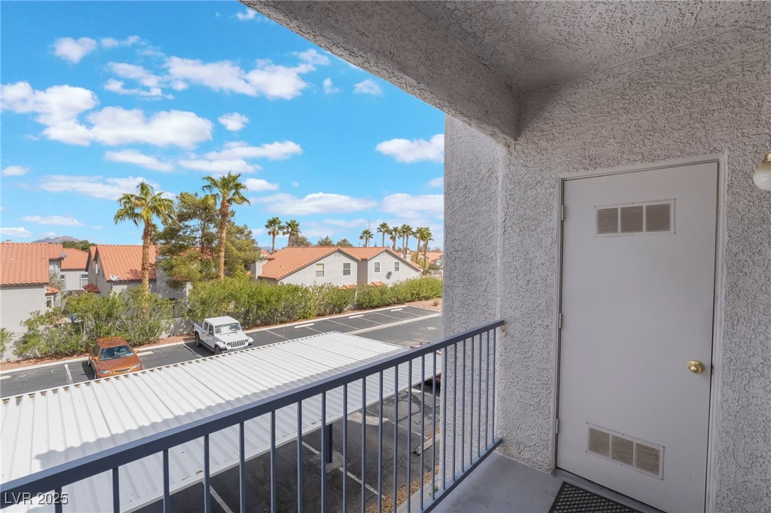 2201 Ramsgate Drive, Unit 823 Henderson, NV 89074 - Photo 26 of 31 Balcony featuring visible vents and a residential view