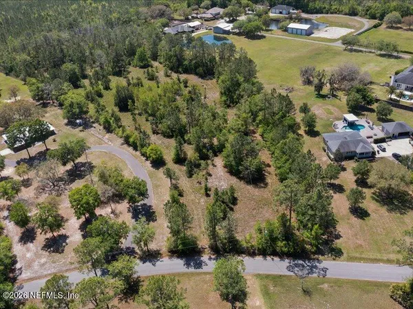 an aerial view of lake residential houses with outdoor space and trees