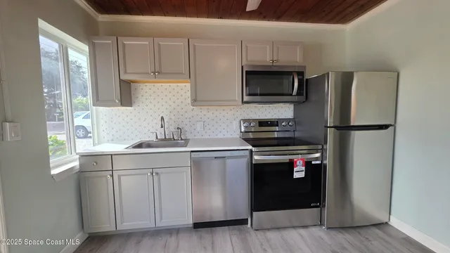 a kitchen with a sink stainless steel appliances and cabinets