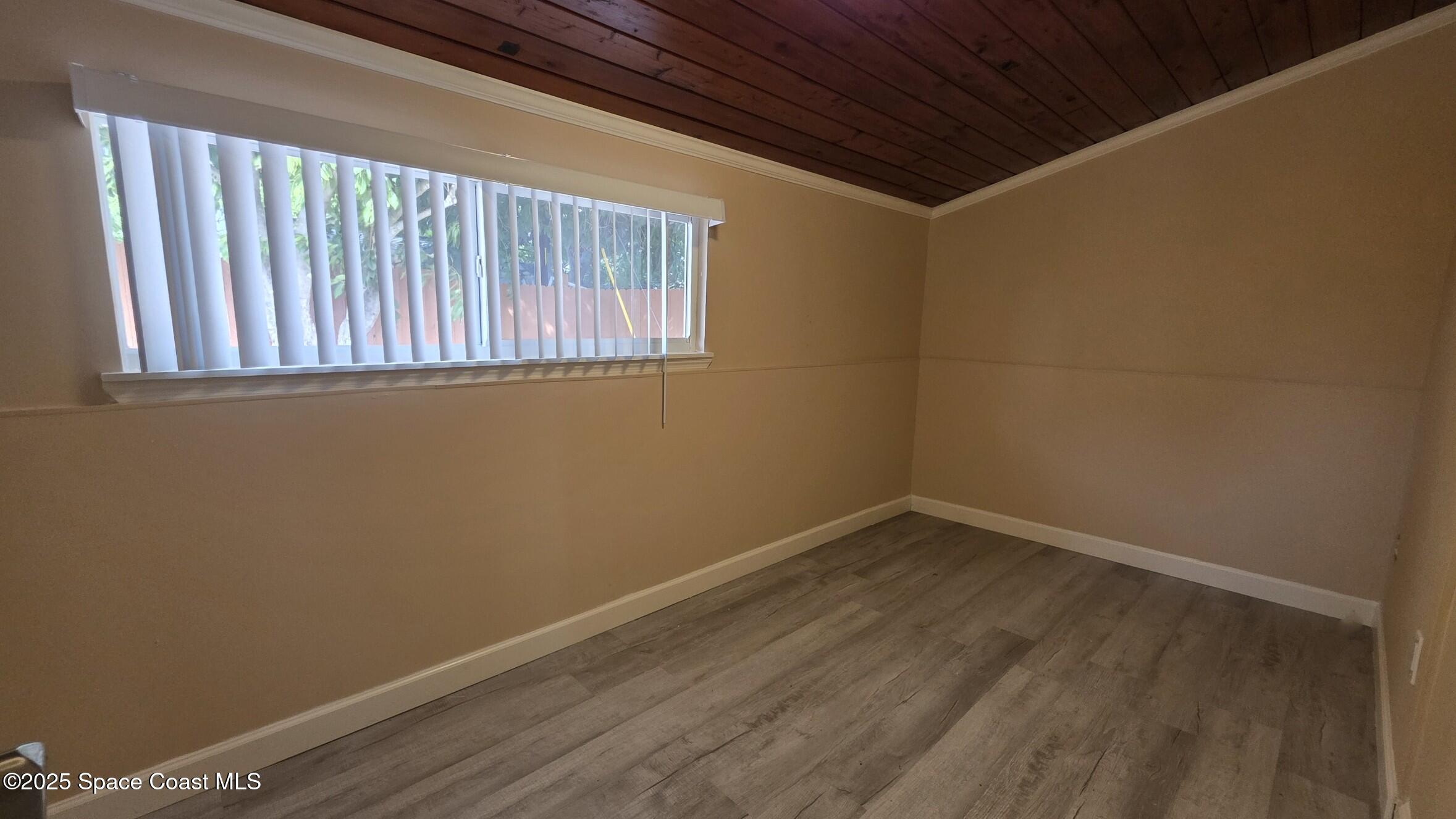6411 Ridgewood Avenue Cocoa Beach, FL 32931 - Photo 9 of 15 a view of an empty room with a window