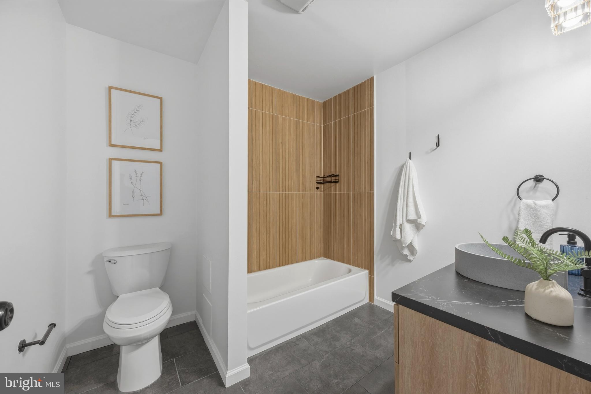 1419 Andre Street Baltimore, MD 21230 - Photo 13 of 25 a bathroom with a toilet a sink and bathtub