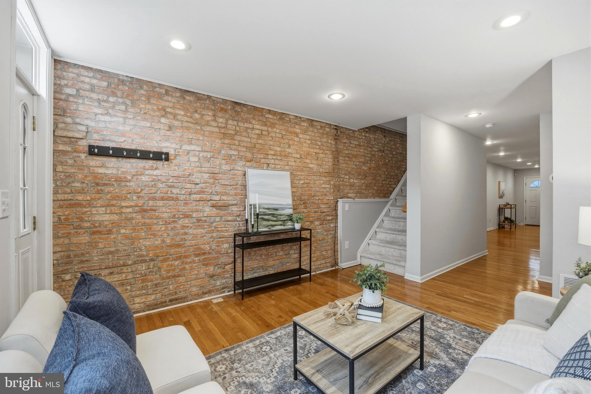 1419 Andre Street Baltimore, MD 21230 - Photo 3 of 25 a living room with patio furniture and a wooden floor