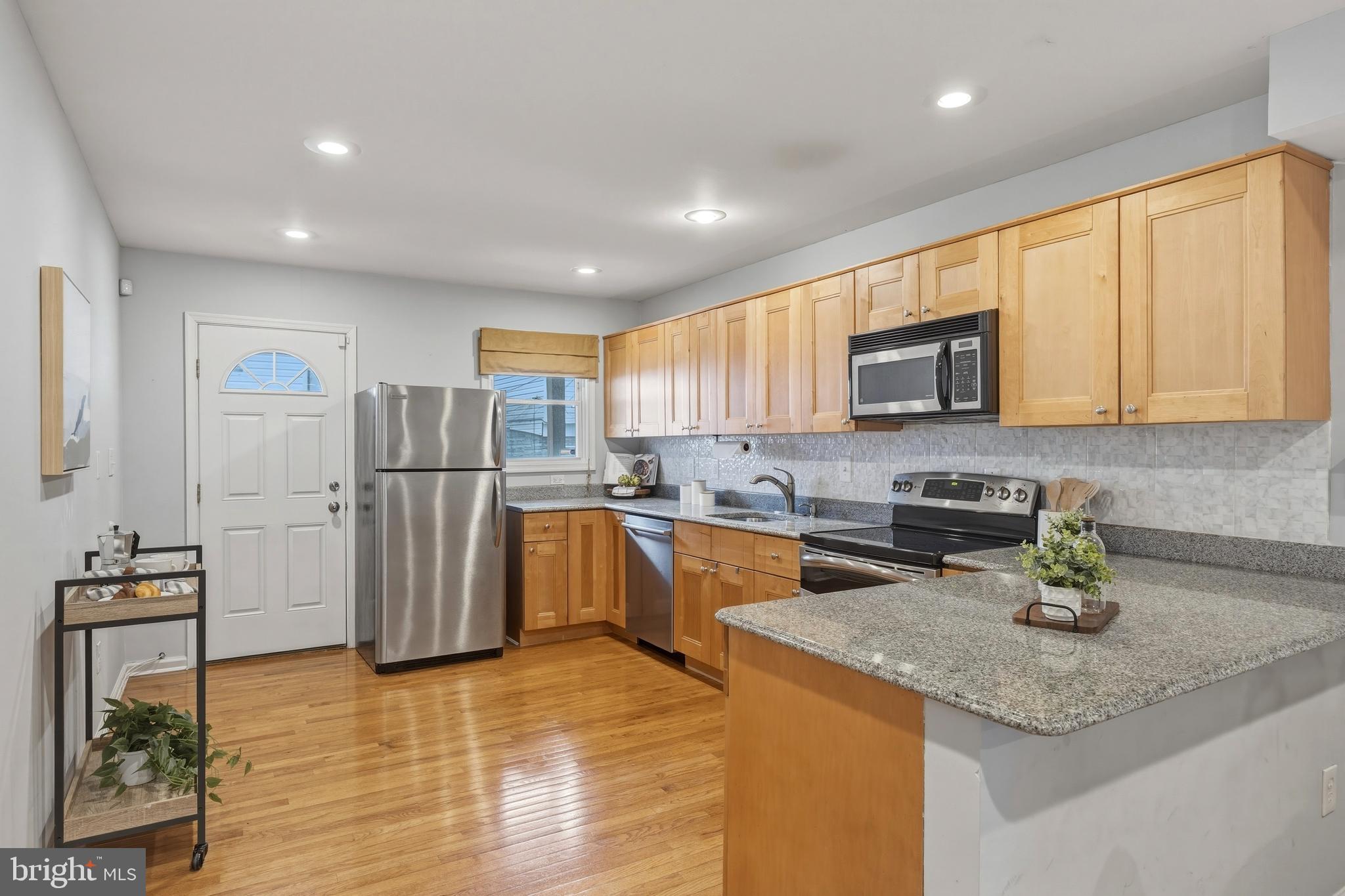 1419 Andre Street Baltimore, MD 21230 - Photo 7 of 25 a kitchen with refrigerator and microwave