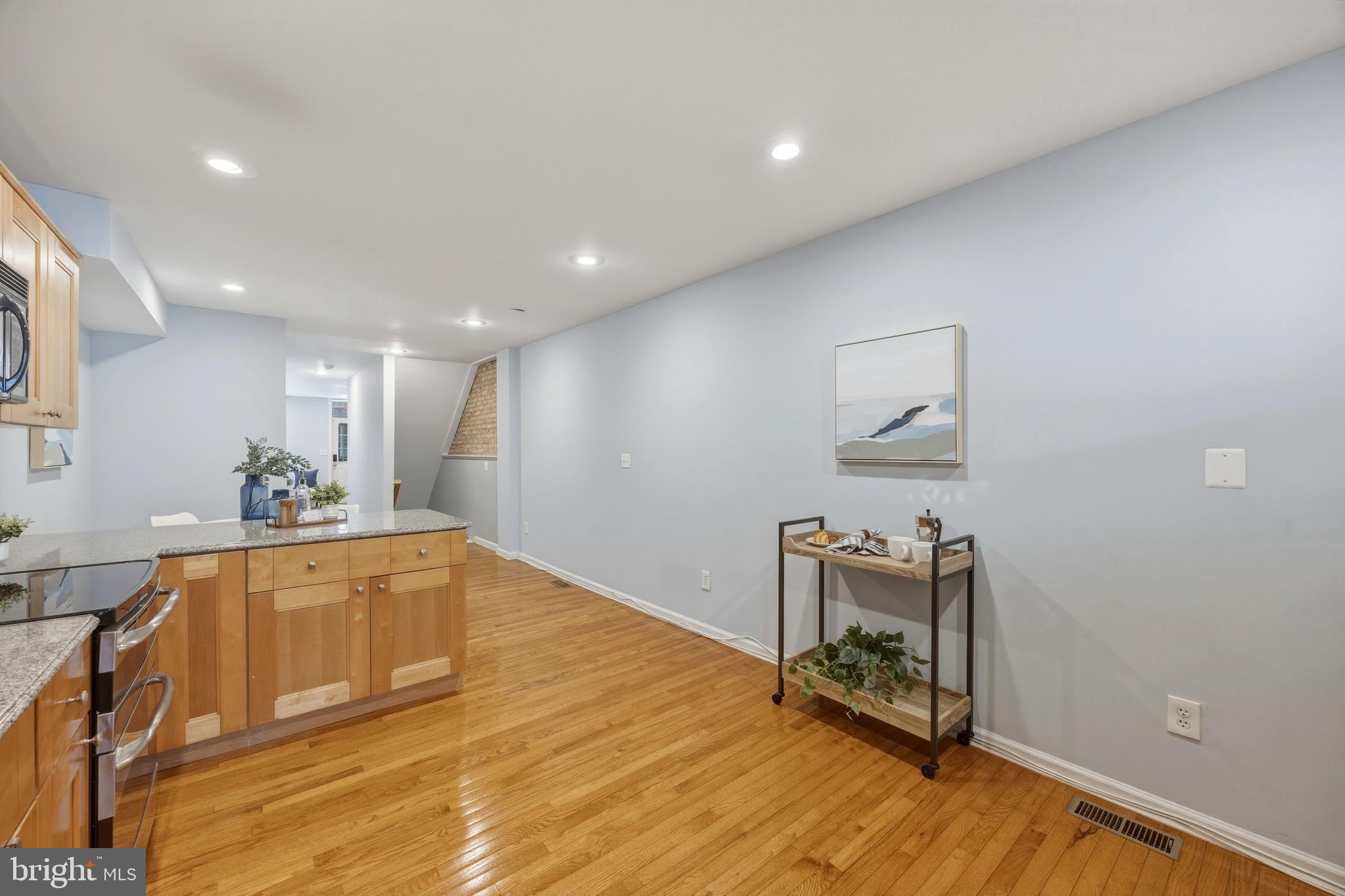 1419 Andre Street Baltimore, MD 21230 - Photo 9 of 25 a large white room with a mirror and a wooden floor