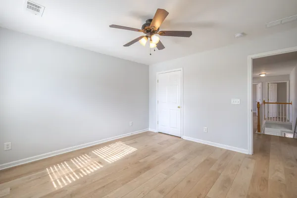 a bathroom with a granite countertop sink two mirror and a bathtub