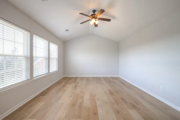 a view of walk in closet with empty racks