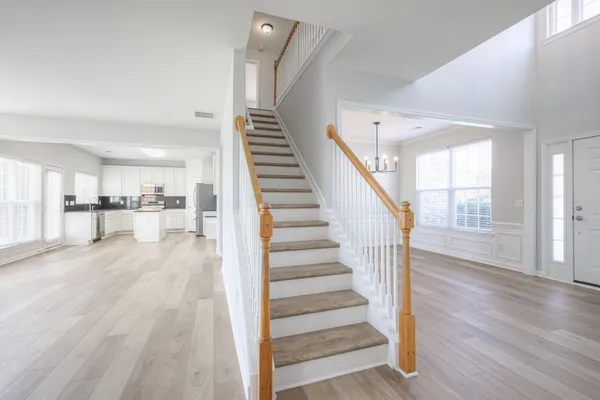 a view of staircase with white walls and windows