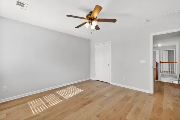 a bathroom with a granite countertop sink two mirror and a bathtub