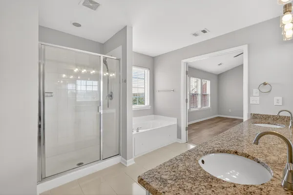 a view of a yard with wooden fence