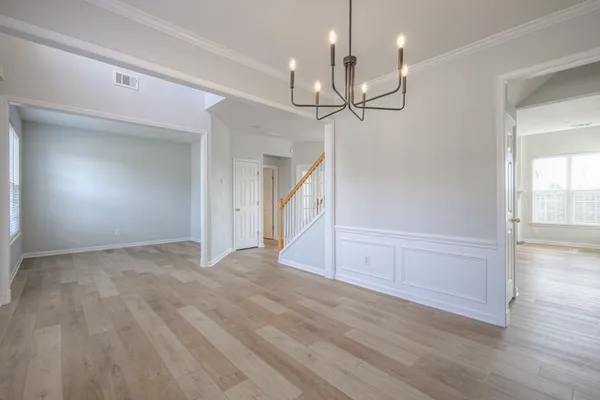 a view of an empty room and wooden floor