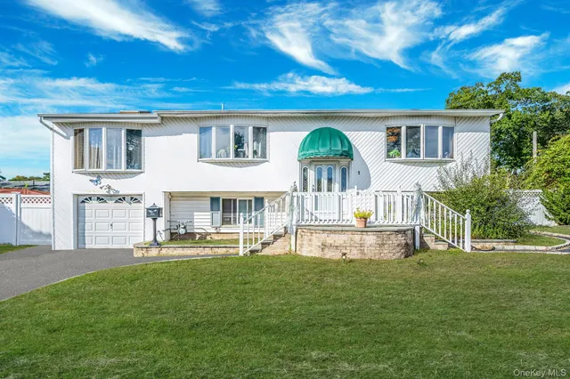 a view of a house with a yard and sitting area