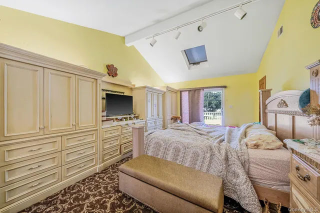 a bedroom with a bed and a couch