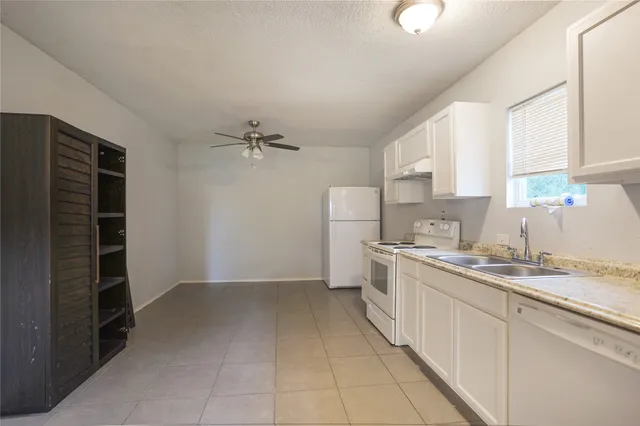 a kitchen with a sink cabinets and window