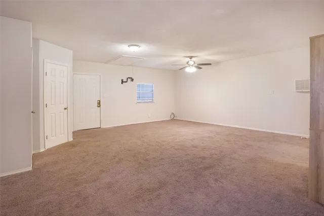 a view of a room with a ceiling fan