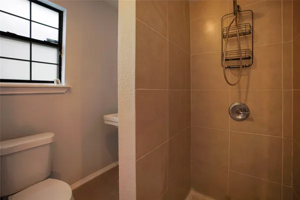 a bathroom with a toilet and a shower