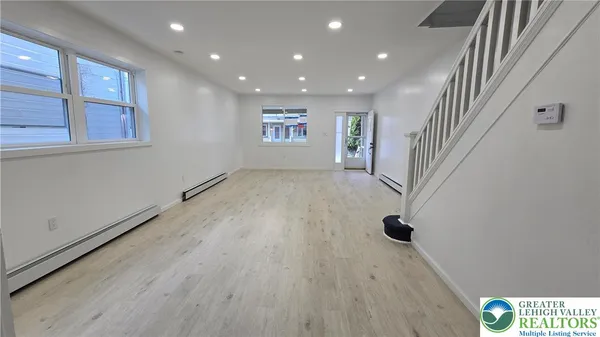 a bathroom with a shower and a window