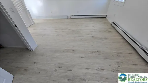 a front view of a house with a tree