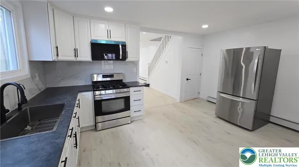 a view of a house with brick walls and stairs