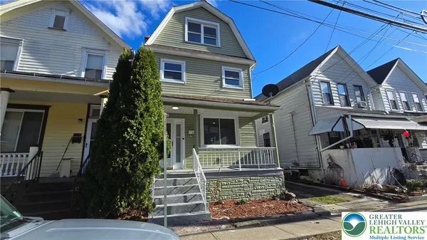 a kitchen with granite countertop white cabinets stainless steel appliances and sink