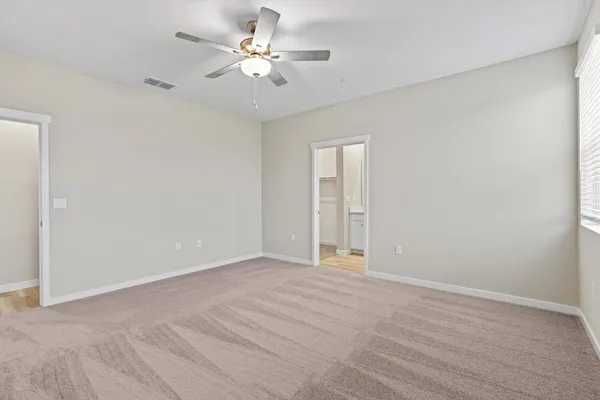 a view of an empty room with a ceiling fan