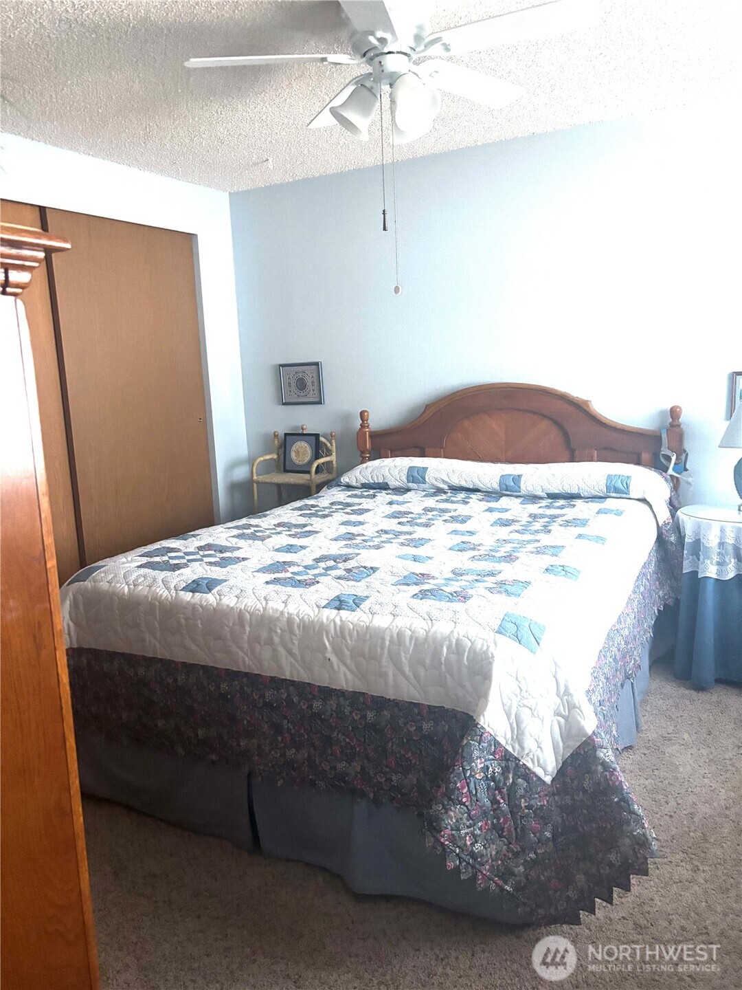 30 Marjory Lane Sequim, WA 98382 - Photo 16 of 22 a bedroom with a bed and a chandelier