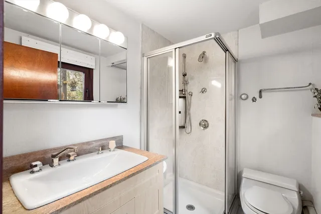a bathroom with a sink toilet and shower