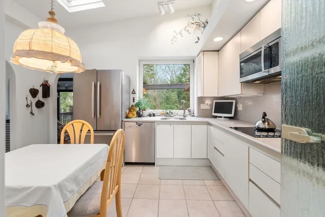 a kitchen that has a cabinets counter space appliances and a window