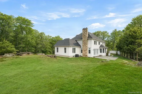 a view of a white house with a yard