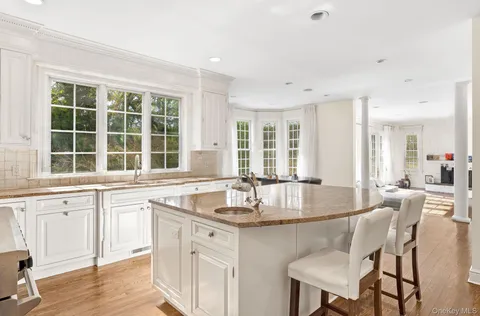 a kitchen with stainless steel appliances granite countertop a sink stove and cabinets