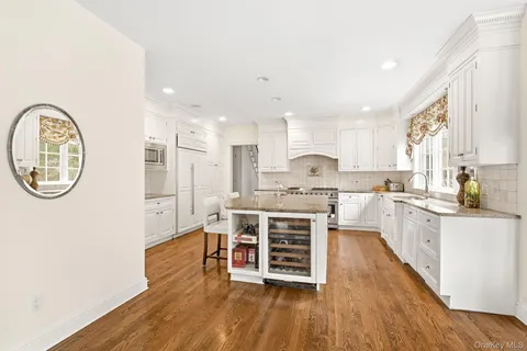 a dining room with wooden floor and windows