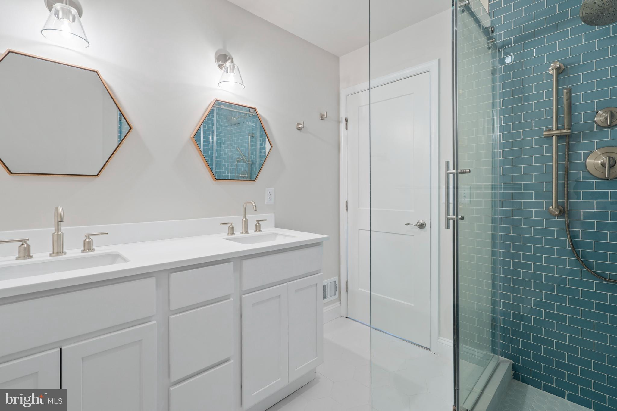 621 Beatty Road Springfield, PA 19064 - Photo 14 of 22 a bathroom with a double vanity sink mirror and shower
