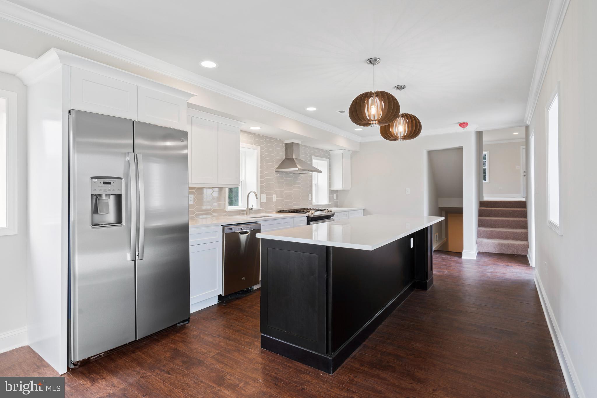 621 Beatty Road Springfield, PA 19064 - Photo 2 of 22 a kitchen with stainless steel appliances granite countertop a sink and a refrigerator