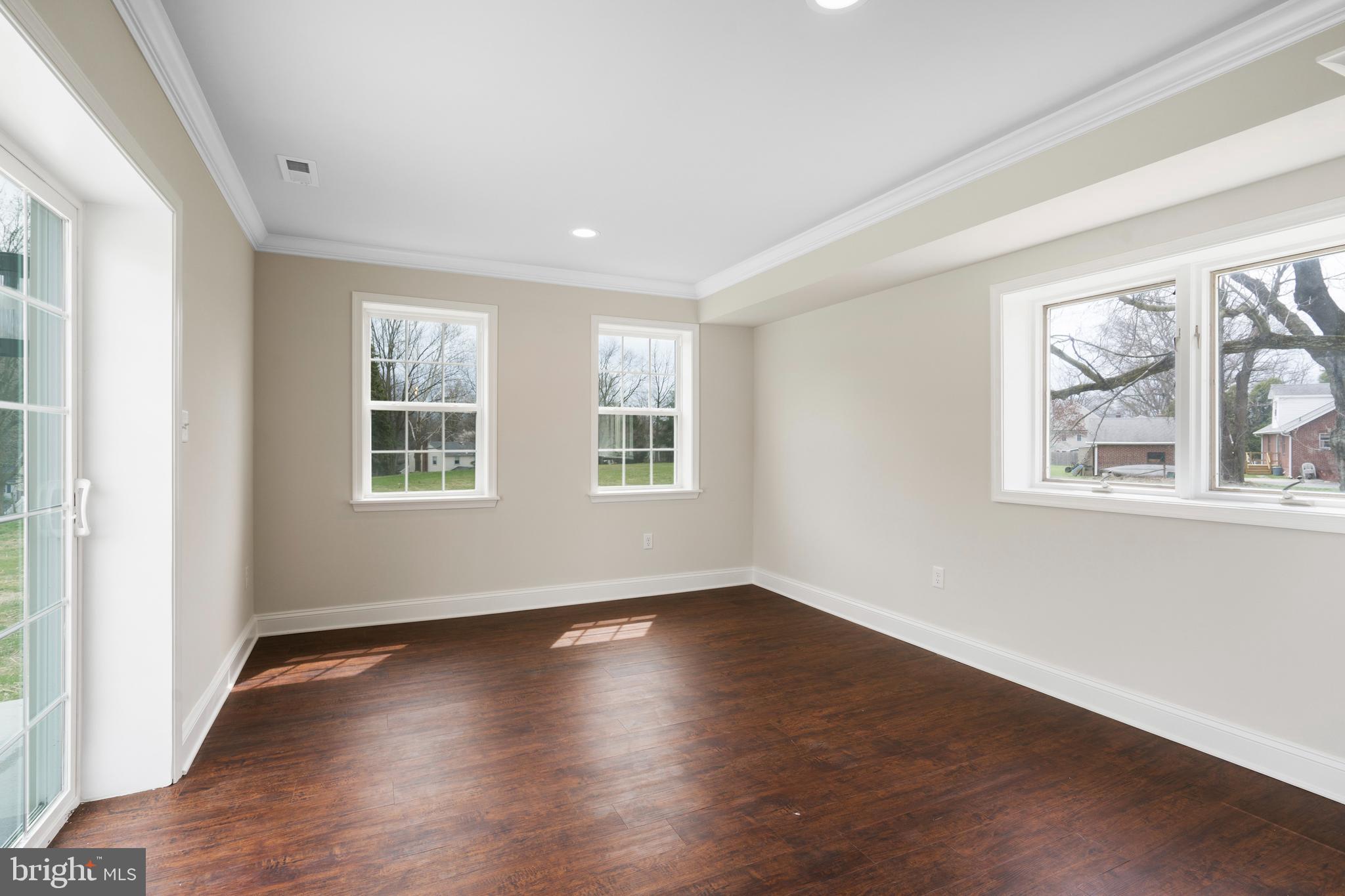621 Beatty Road Springfield, PA 19064 - Photo 3 of 22 a view of empty room with wooden floor and fan