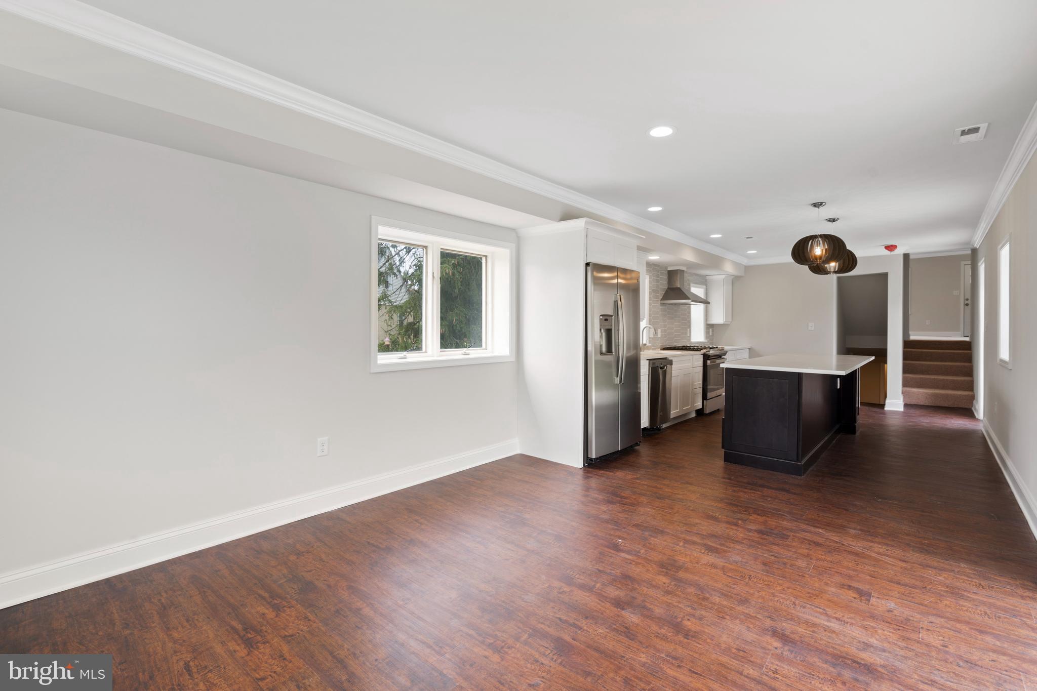 621 Beatty Road Springfield, PA 19064 - Photo 5 of 22 a view of a big room with wooden floor and windows