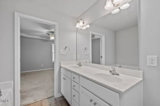 a bathroom with a double vanity sink and a mirror