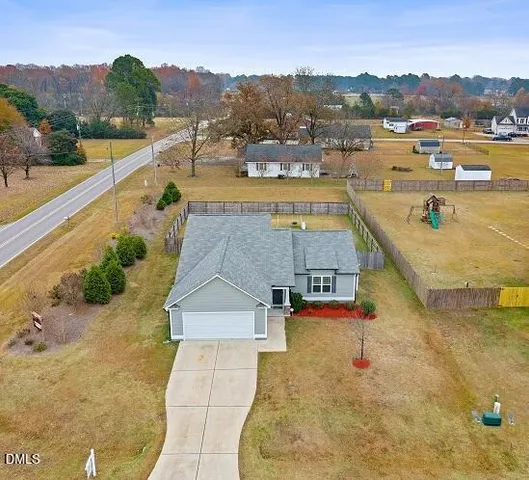 a view of a house with a yard and roof