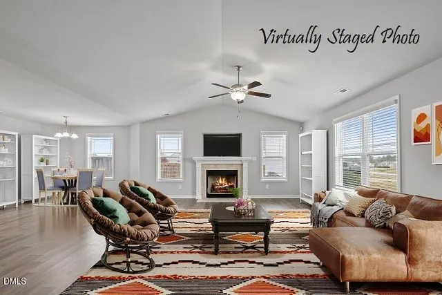 a living room with furniture fireplace and a large window