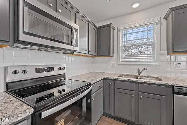 a kitchen with a stove microwave and sink