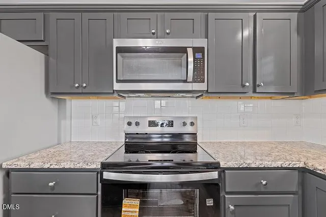 a stove top oven sitting inside of a kitchen