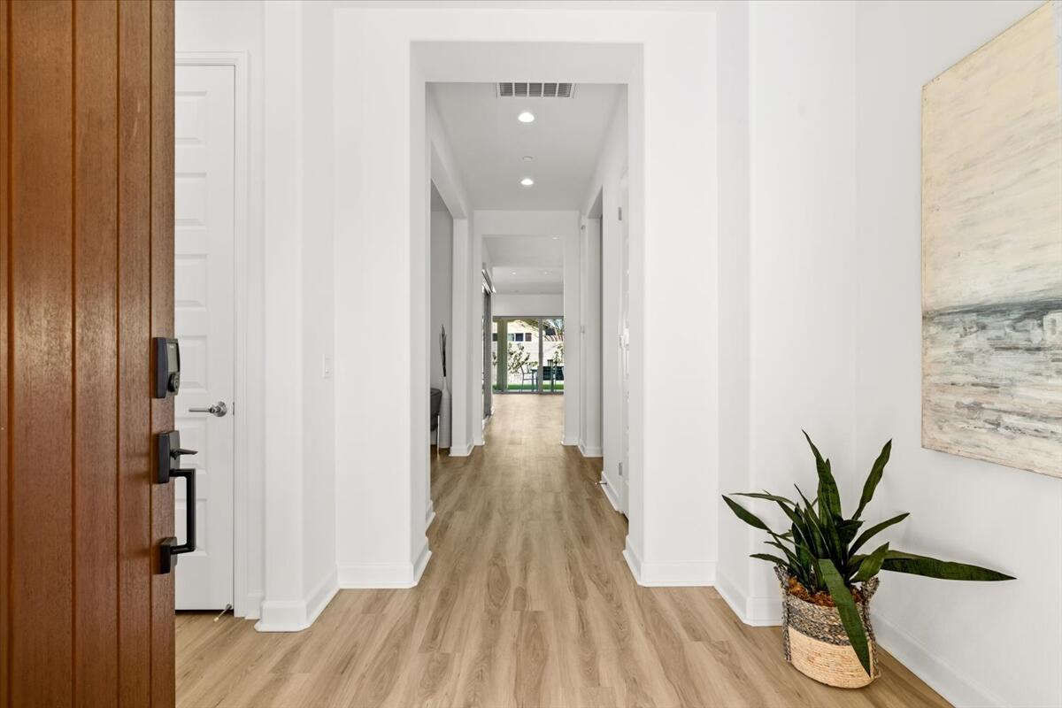 10 Gamay Rancho Mirage, CA 92270 - Photo 3 of 86 a view of a hallway with wooden floor and a bathroom
