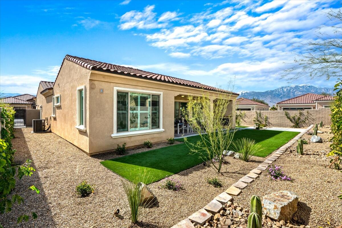 10 Gamay Rancho Mirage, CA 92270 - Photo 38 of 86 a view of a house with a small yard plants and a large tree